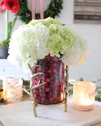 Cranberry Vase Arrangement: Festive cranberry vase arrangement with pine clippings for holiday decor.